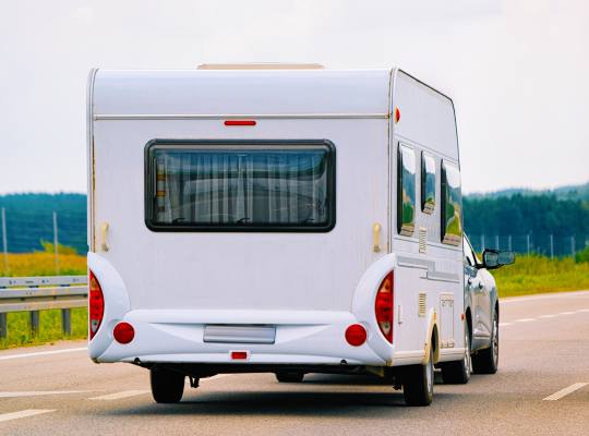 A car towing a caravan on a road
