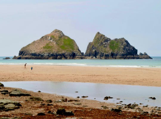 Family on the sand at Holywell Bay Beach, Near Newquay